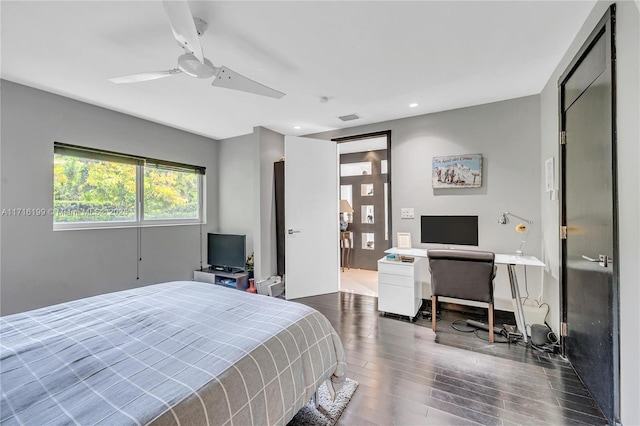 bedroom with ceiling fan and dark wood-type flooring