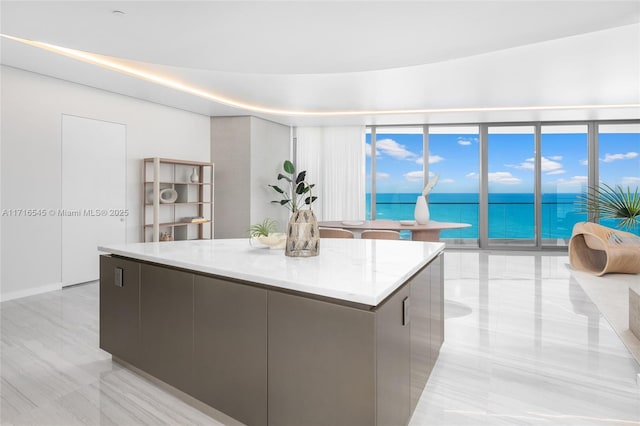 kitchen with a water view, expansive windows, and a large island