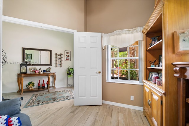 sitting room featuring light wood-type flooring and baseboards