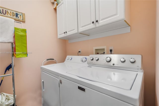 clothes washing area featuring cabinet space and washing machine and dryer