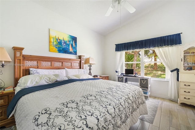 bedroom with ceiling fan, lofted ceiling, and wood finished floors