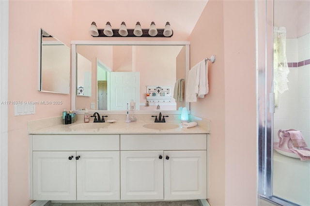 full bath with a shower stall, double vanity, and a sink