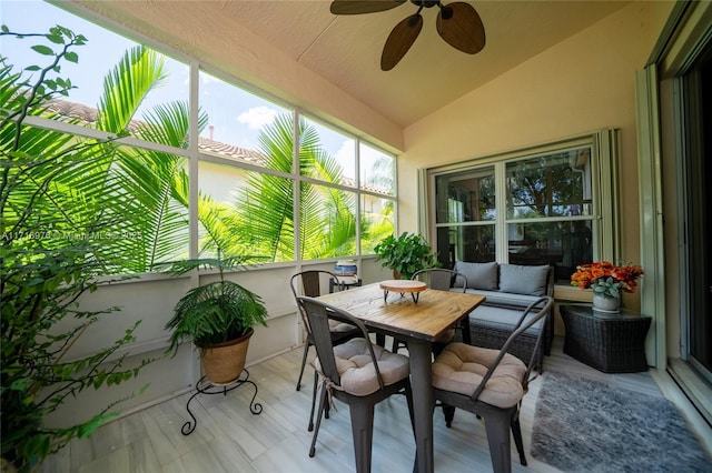 sunroom with ceiling fan and vaulted ceiling