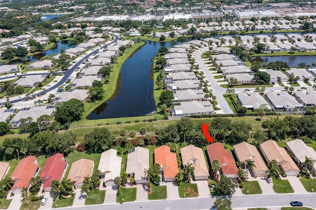 drone / aerial view featuring a residential view and a water view