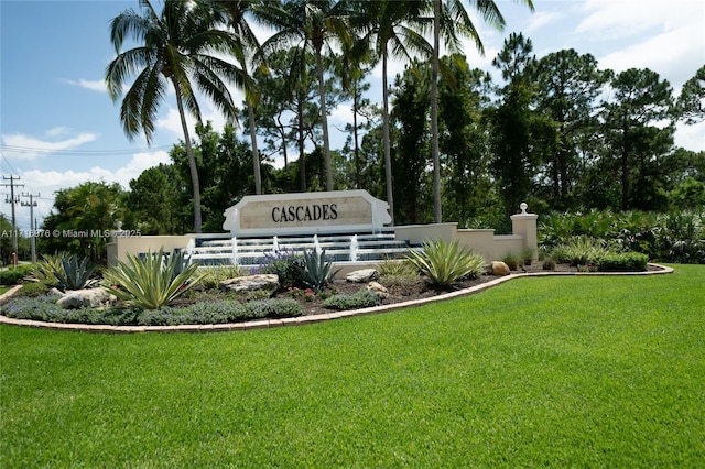 community sign with a yard and fence