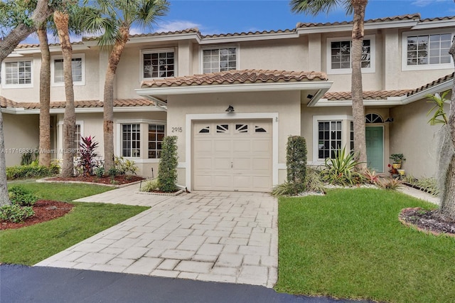 mediterranean / spanish house with a garage and a front yard