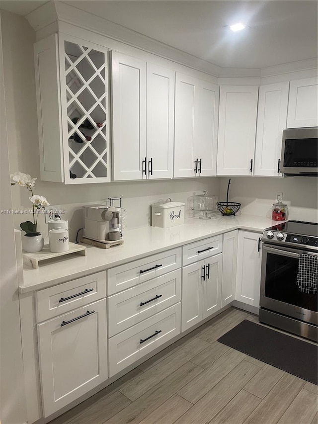 kitchen with stainless steel appliances and white cabinetry