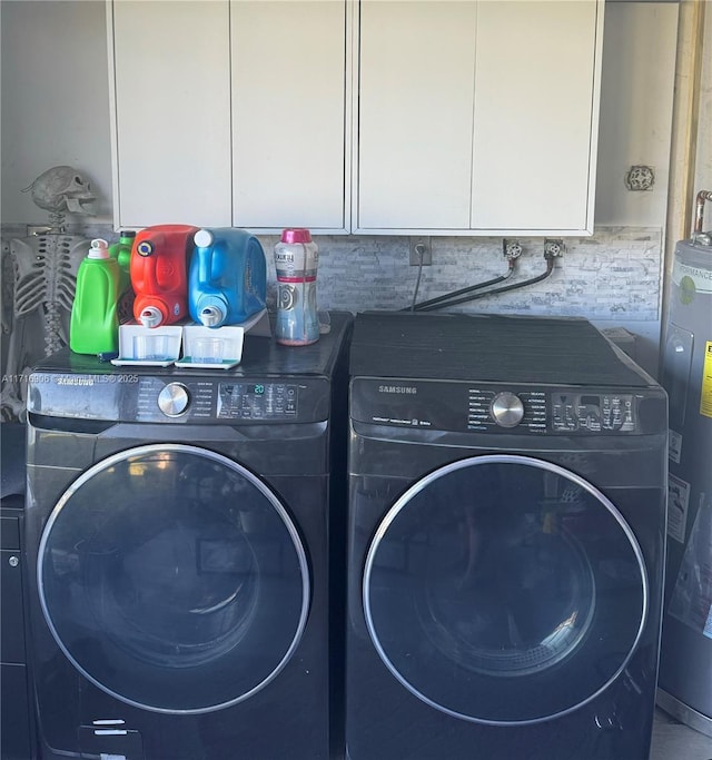 laundry area with water heater, cabinets, and independent washer and dryer