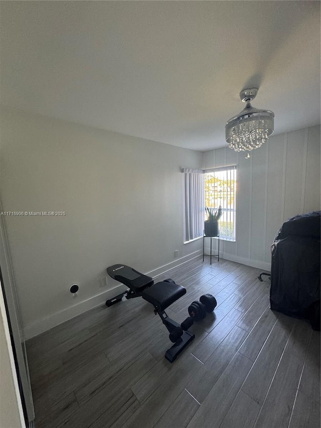 workout area featuring a notable chandelier