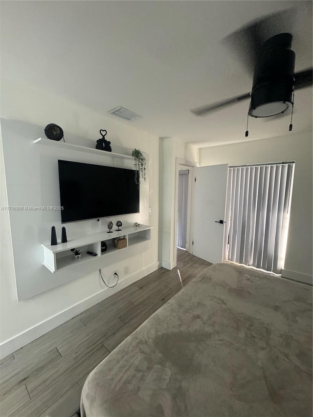 bedroom featuring hardwood / wood-style floors and ceiling fan