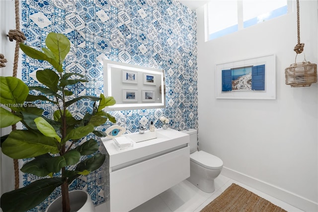 bathroom featuring toilet, vanity, and tile patterned floors