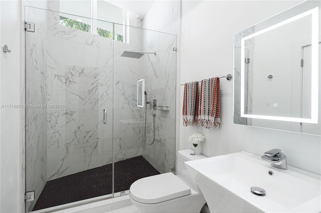 bathroom featuring toilet, sink, and walk in shower