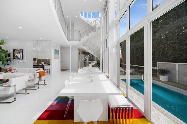 dining area with tile patterned flooring and a high ceiling