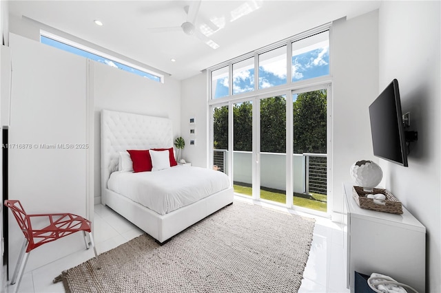 bedroom with ceiling fan, a towering ceiling, and light tile patterned flooring