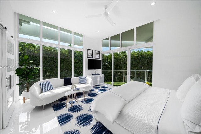 bedroom featuring floor to ceiling windows and ceiling fan