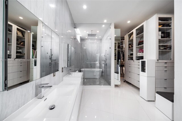 bathroom with tile patterned floors, independent shower and bath, and tile walls