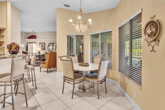 dining room with a notable chandelier, light tile patterned floors, and sink