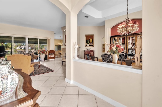 hall featuring light tile patterned floors and an inviting chandelier