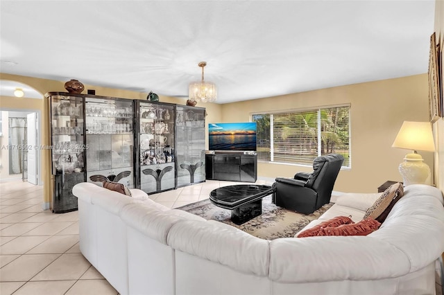 living room featuring light tile patterned floors and an inviting chandelier