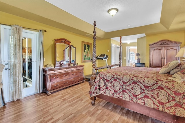 bedroom featuring light hardwood / wood-style floors and a textured ceiling