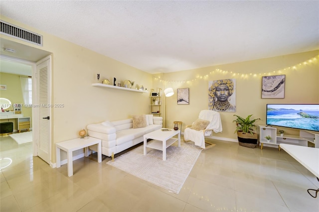 tiled living room with a textured ceiling