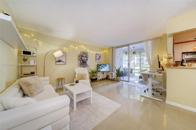 living room with expansive windows, light tile patterned floors, and a textured ceiling