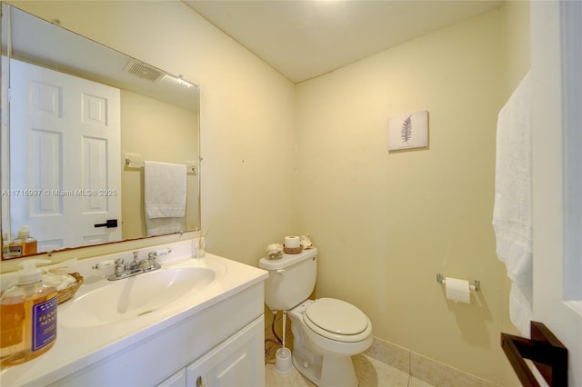 bathroom with vanity, tile patterned floors, and toilet