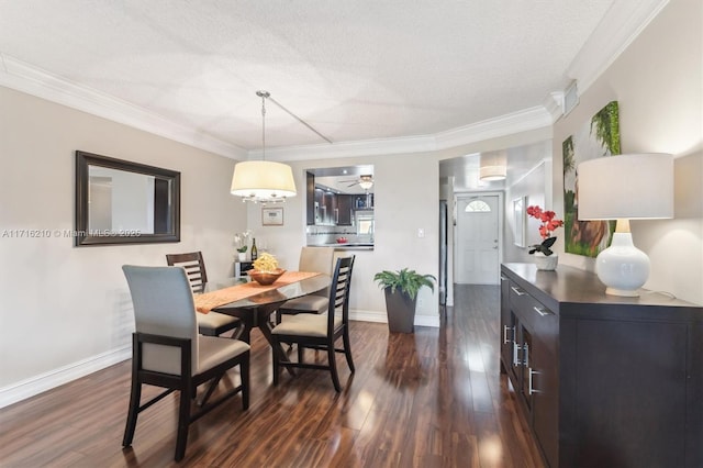 dining area featuring a textured ceiling, ceiling fan, ornamental molding, and dark hardwood / wood-style floors