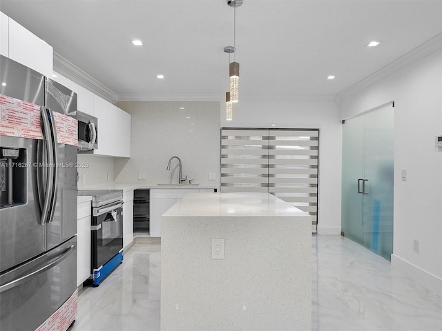 kitchen featuring white cabinets, decorative light fixtures, a center island, and stainless steel appliances