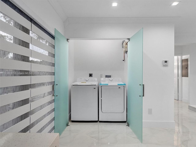 clothes washing area featuring electric panel, crown molding, and washer and clothes dryer