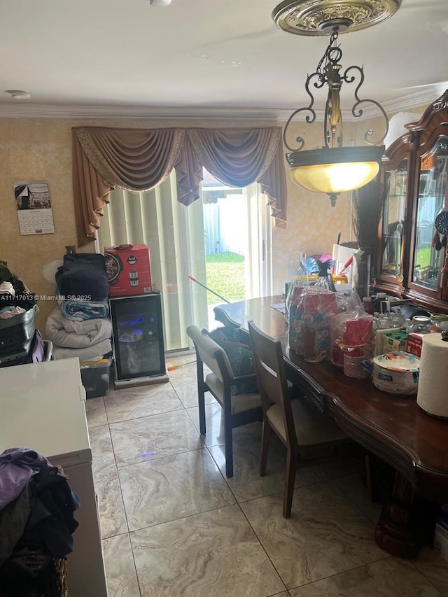 dining space with ornamental molding and beverage cooler