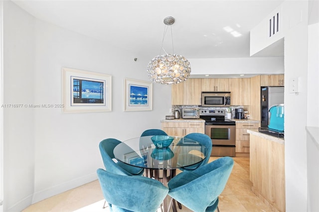 dining space featuring light tile patterned floors and a notable chandelier