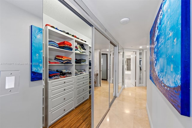 corridor featuring light tile patterned floors