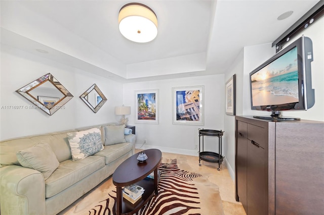 living room with a tray ceiling