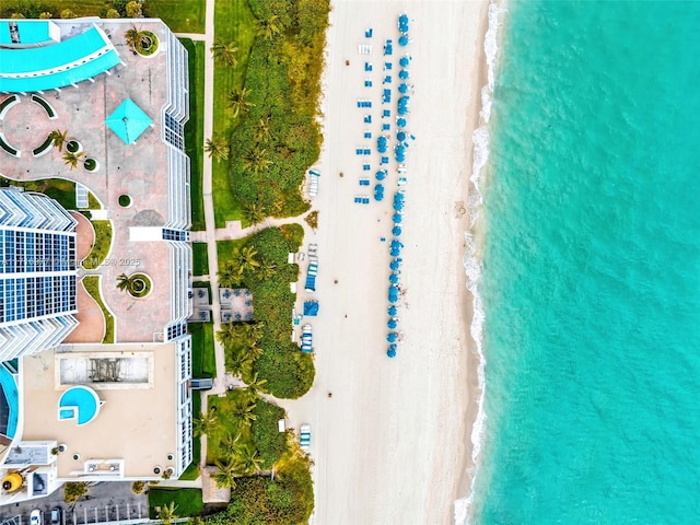 drone / aerial view with a beach view and a water view