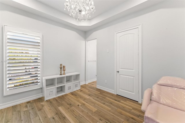 interior space featuring light wood-type flooring and an inviting chandelier