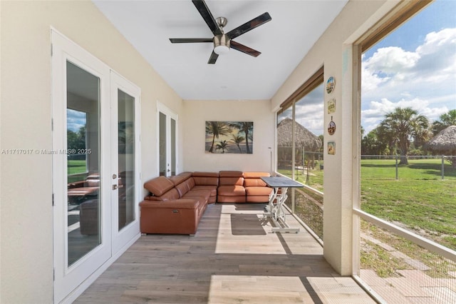 sunroom featuring french doors and ceiling fan