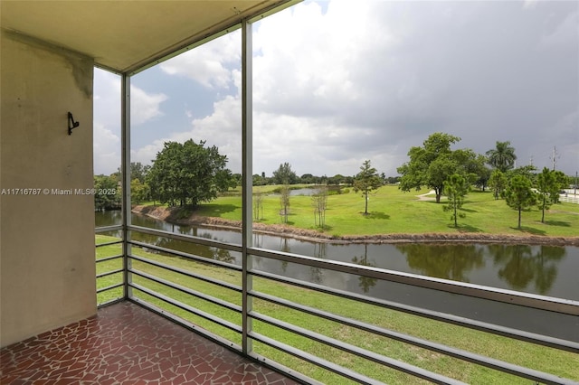 unfurnished sunroom with a water view