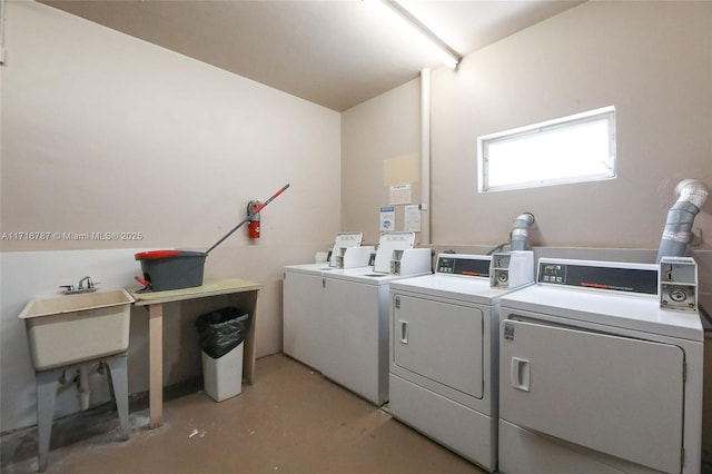 clothes washing area with washer and clothes dryer