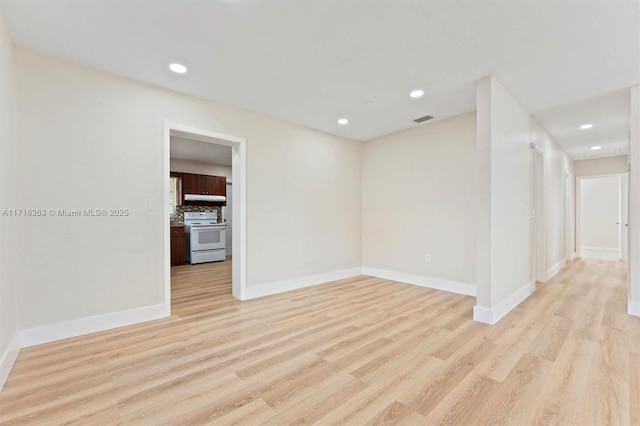 unfurnished room with light wood-type flooring