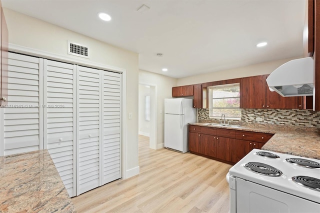 kitchen with sink, electric range oven, tasteful backsplash, range hood, and white refrigerator