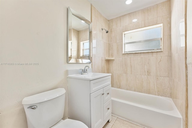 full bathroom with tile patterned flooring, toilet, vanity, and tiled shower / bath