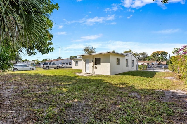 rear view of house featuring a yard