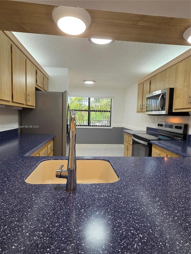 2606 NW 104th Ave Unit 202, Sunrise, FL 33322 - kitchen with stainless steel appliances, dark countertops, and a textured ceiling