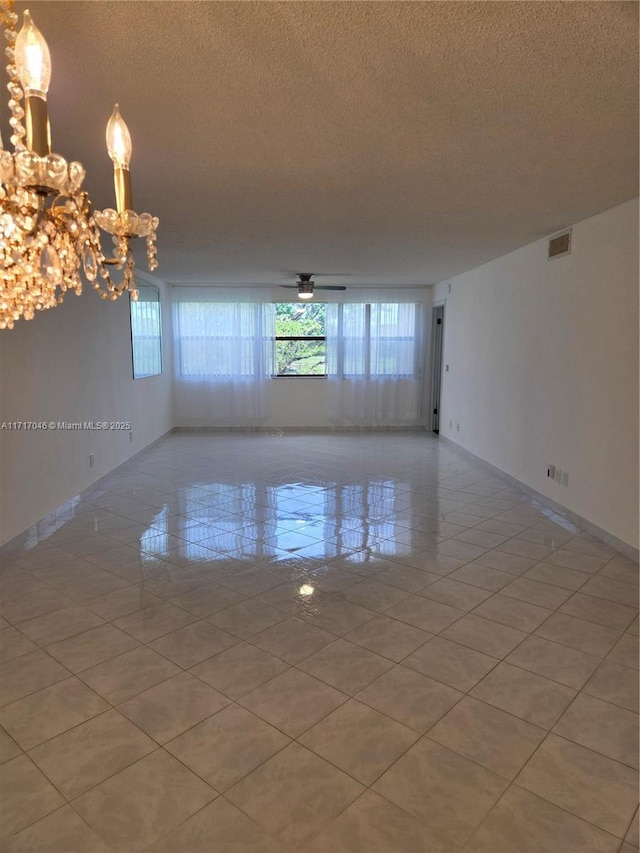 2606 NW 104th Ave Unit 202, Sunrise, FL 33322 - empty room featuring a textured ceiling, a chandelier, and light tile patterned floors