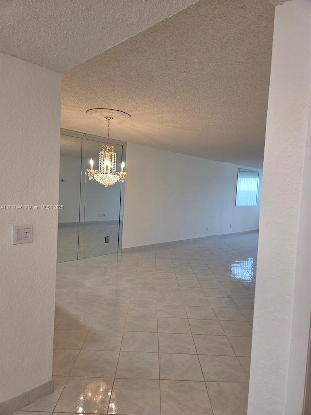 2606 NW 104th Ave Unit 202, Sunrise, FL 33322 - tiled empty room with a textured ceiling, a chandelier, and a textured wall