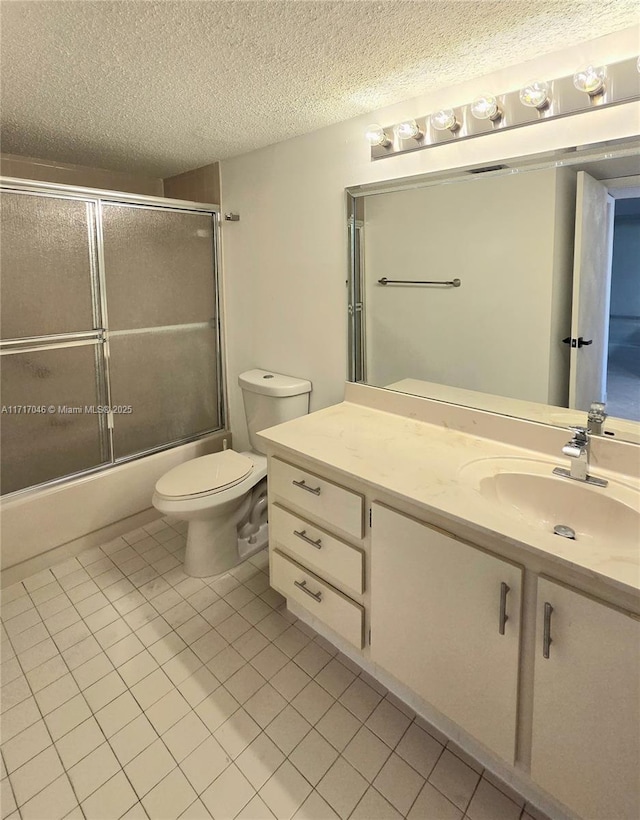 2606 NW 104th Ave Unit 202, Sunrise, FL 33322 - full bath with tile patterned flooring, vanity, a textured ceiling, and combined bath / shower with glass door