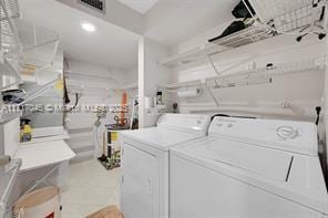 clothes washing area featuring independent washer and dryer