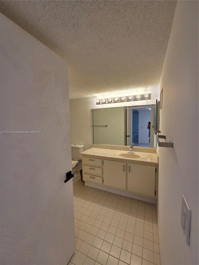 2606 NW 104th Ave Unit 202, Sunrise, FL 33322 - bathroom with tile patterned flooring, vanity, and a textured ceiling