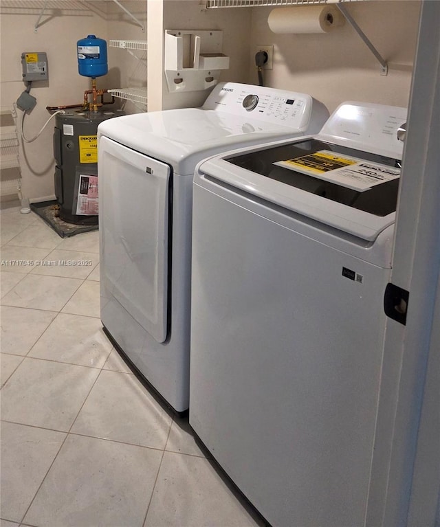 2606 NW 104th Ave Unit 202, Sunrise, FL 33322 - laundry room featuring washing machine and dryer, electric water heater, and light tile patterned floors